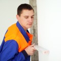 Young worker with level