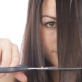 Young Woman Cutting Hair. Model Released