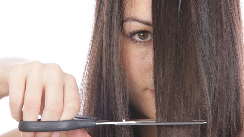 Young Woman Cutting Hair. Model Released