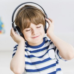 Cute boy wearing headphones and enjoying music