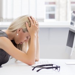 Overworked and tired young woman in front of computer