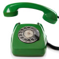 Green retro telephone on white background